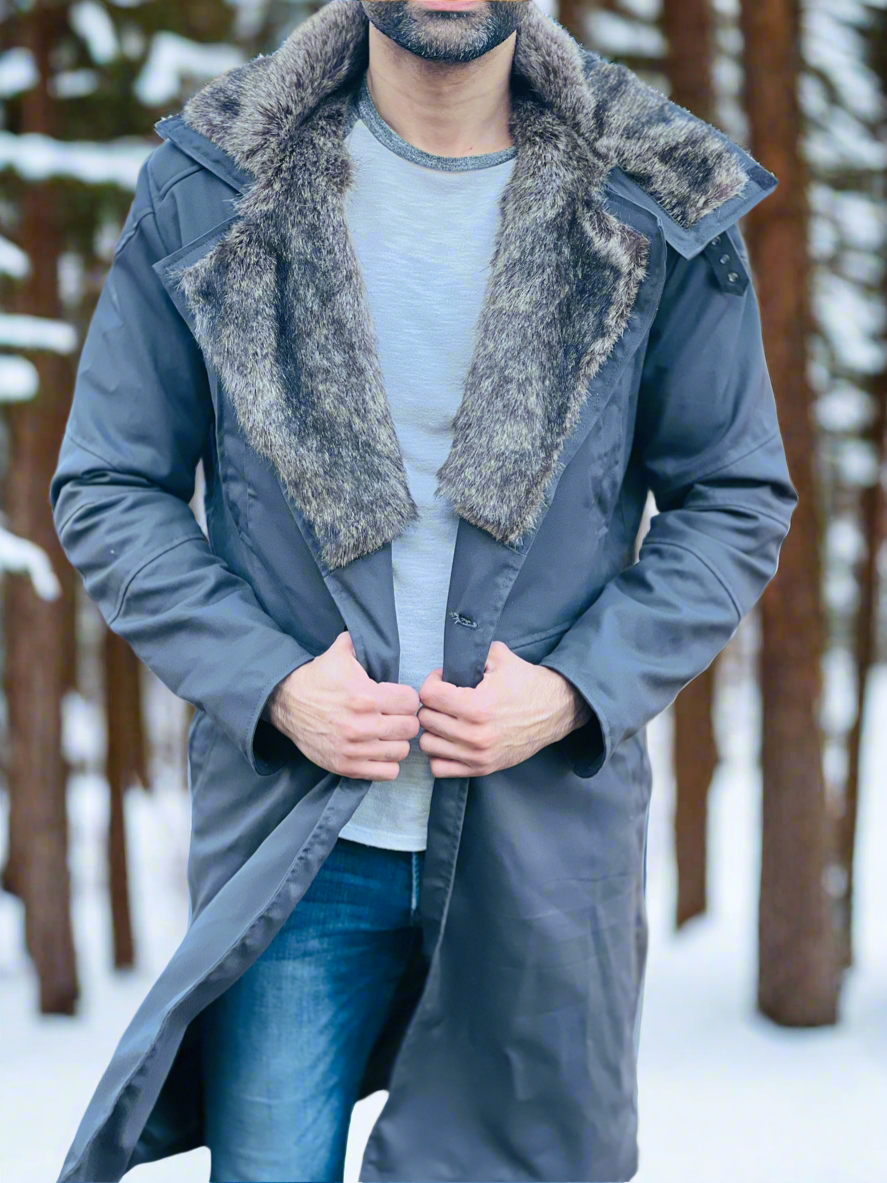 Person wearing a long coat with fur collar in a snowy forest setting